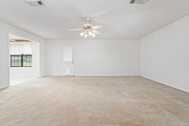 carpeted spare room featuring ceiling fan