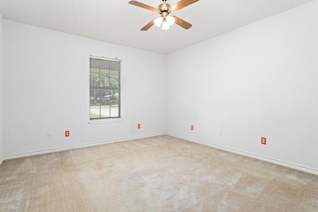 spare room with light carpet and ceiling fan