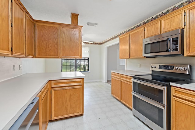 kitchen featuring kitchen peninsula and appliances with stainless steel finishes