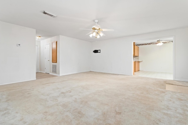 carpeted empty room featuring ceiling fan