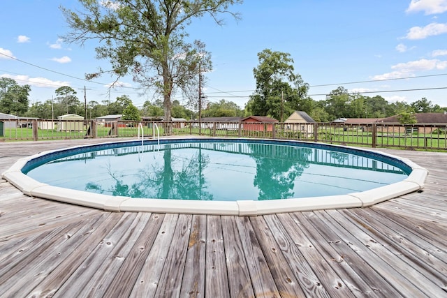 view of swimming pool featuring a wooden deck