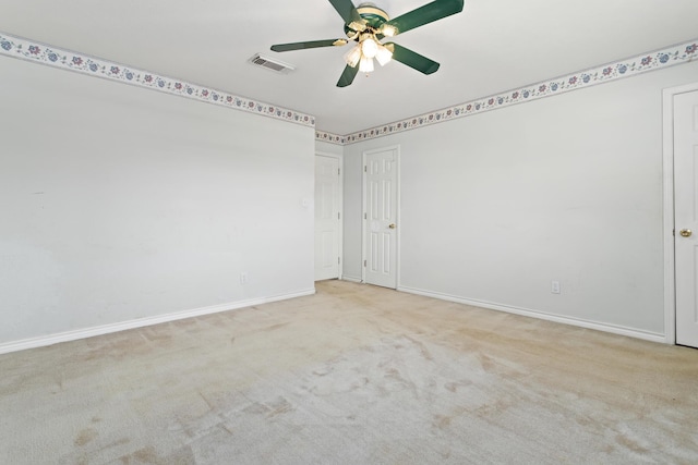 unfurnished room featuring light carpet and ceiling fan