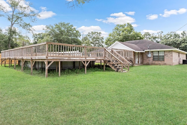 rear view of property with a yard and a deck