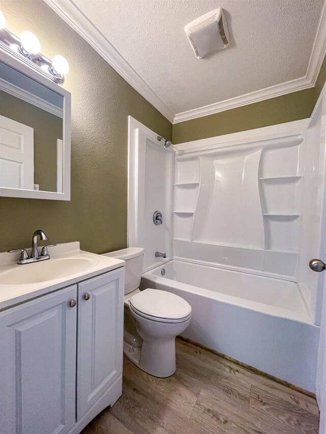1510 S Timberlane St, Vidor, TX 77662 - bathroom with ornamental molding, wood finished floors, vanity, a textured ceiling, and shower / tub combination