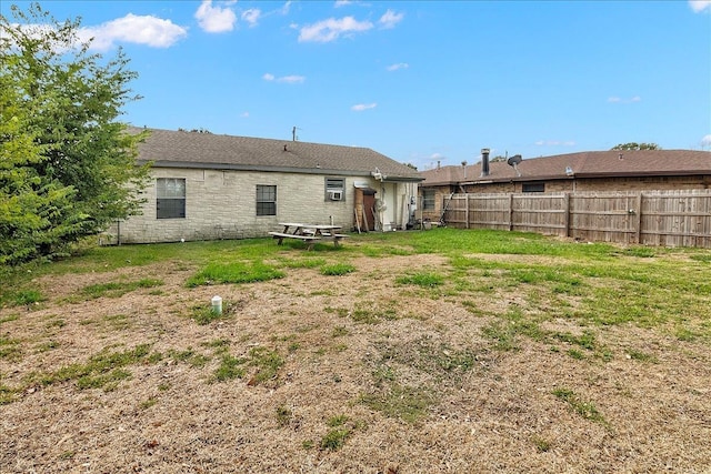 rear view of house with a yard