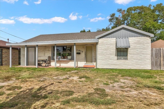 view of front of house with a patio and a front lawn