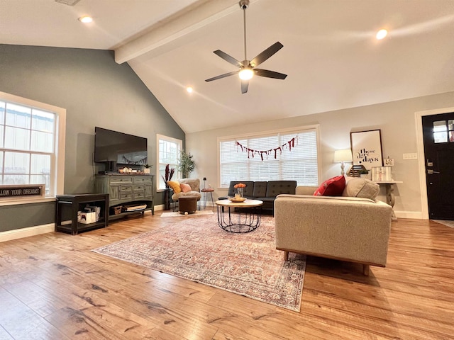 living room with beamed ceiling, ceiling fan, high vaulted ceiling, and light hardwood / wood-style floors