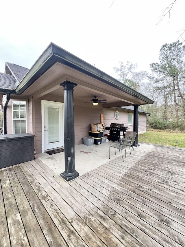 wooden terrace with ceiling fan and a patio area