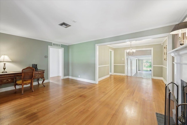 623 20th St, Beaumont, TX 77706 - office featuring a chandelier, light wood finished floors, a fireplace with flush hearth, crown molding, and baseboards