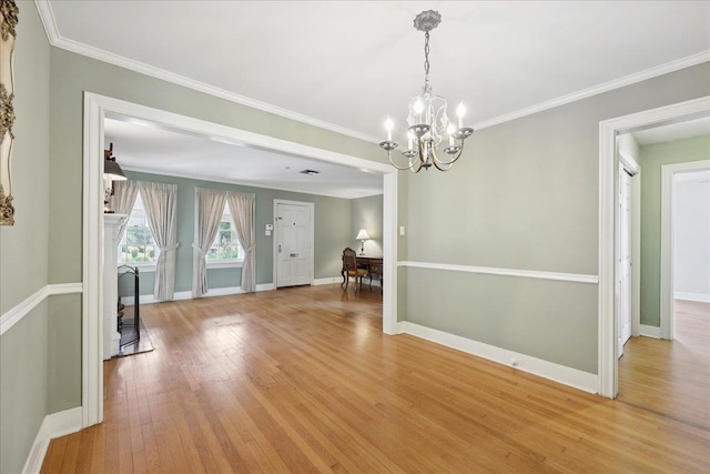 623 20th St, Beaumont, TX 77706 - unfurnished dining area with a chandelier, baseboards, light wood-style floors, and ornamental molding