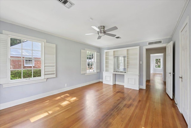 623 20th St, Beaumont, TX 77706 - unfurnished bedroom featuring crown molding, wood finished floors, baseboards, and ceiling fan