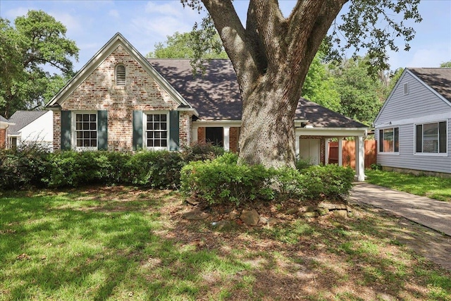 623 20th St, Beaumont, TX 77706 - view of front of house featuring brick siding, a front yard, and concrete driveway