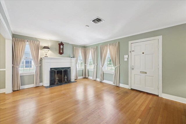 623 20th St, Beaumont, TX 77706 - unfurnished living room featuring hardwood / wood-style floors, baseboards, ornamental molding, and a fireplace
