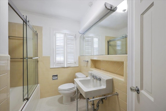 623 20th St, Beaumont, TX 77706 - full bathroom with tile walls, toilet, enclosed tub / shower combo, tile patterned floors, and a sink