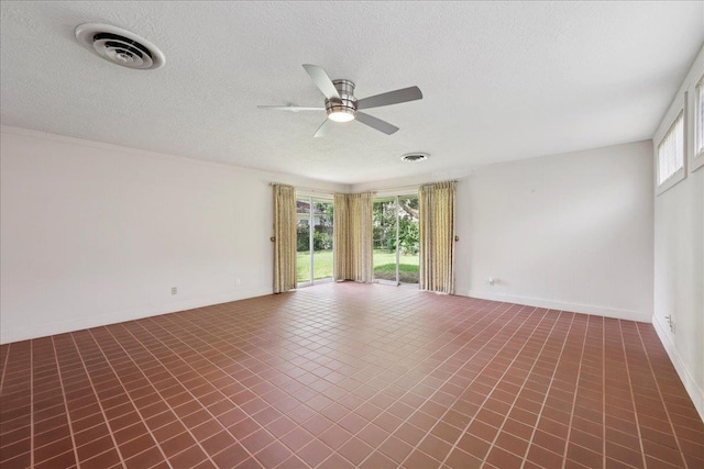 623 20th St, Beaumont, TX 77706 - tiled spare room with a ceiling fan, plenty of natural light, and a textured ceiling