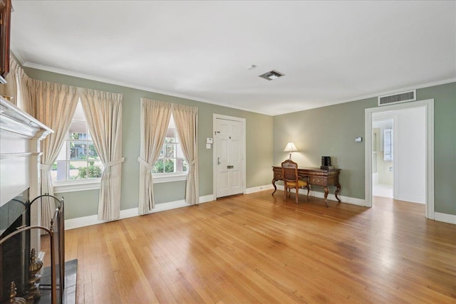 623 20th St, Beaumont, TX 77706 - entrance foyer featuring light wood finished floors, ornamental molding, and baseboards