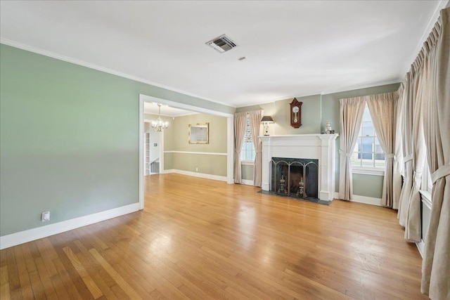 623 20th St, Beaumont, TX 77706 - unfurnished living room with a chandelier, baseboards, light wood-type flooring, a fireplace, and ornamental molding