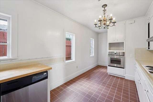623 20th St, Beaumont, TX 77706 - kitchen featuring appliances with stainless steel finishes, a chandelier, white cabinetry, wood counters, and crown molding
