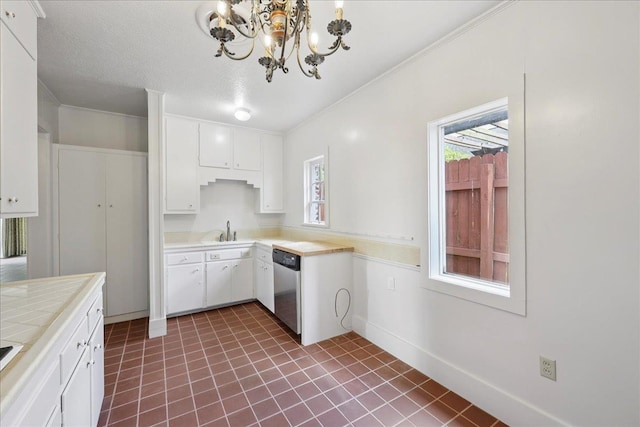 623 20th St, Beaumont, TX 77706 - kitchen with stainless steel dishwasher, a sink, a chandelier, tile counters, and white cabinetry