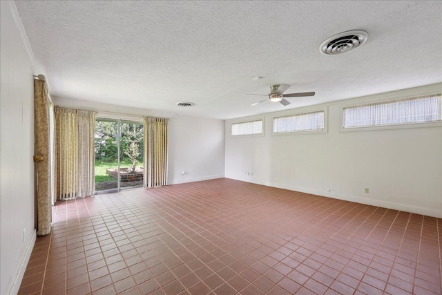 623 20th St, Beaumont, TX 77706 - empty room with ceiling fan, plenty of natural light, baseboards, and a textured ceiling