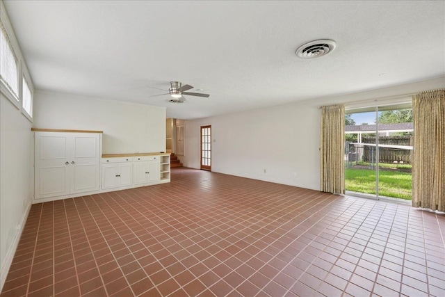 623 20th St, Beaumont, TX 77706 - spare room featuring healthy amount of natural light, ceiling fan, and tile patterned floors