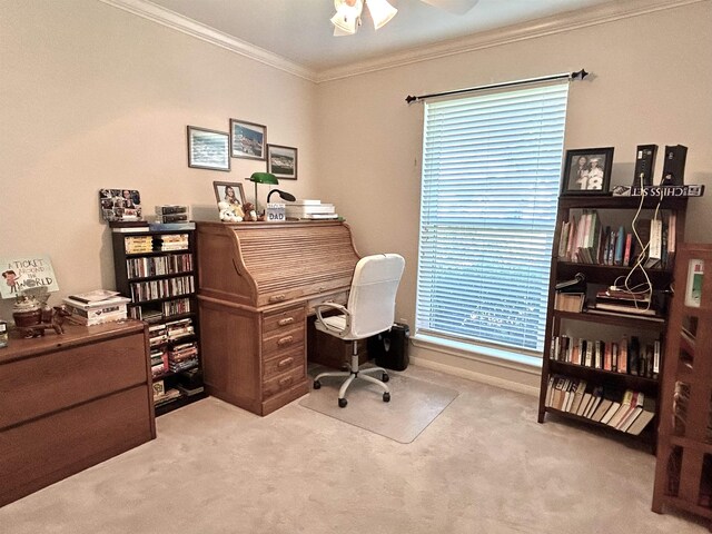 office area featuring ceiling fan, a healthy amount of sunlight, ornamental molding, and light carpet