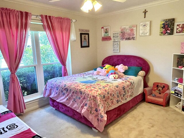 bedroom with carpet, ceiling fan, and crown molding