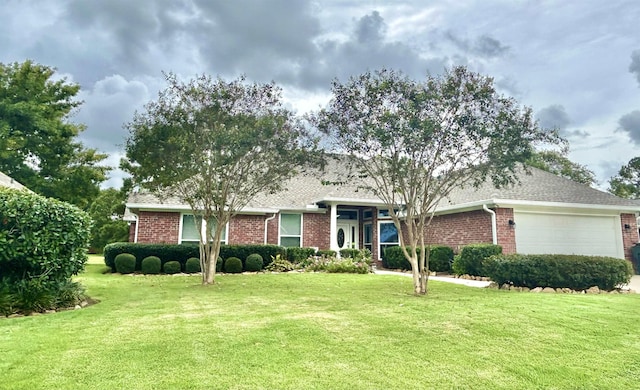 ranch-style home with a garage and a front lawn