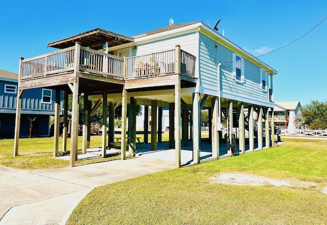 back of property with a wooden deck and a yard