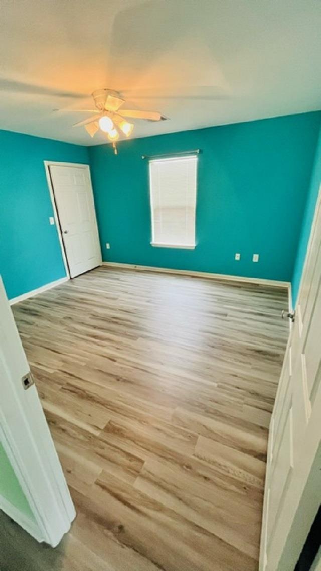 interior space with ceiling fan and light hardwood / wood-style floors