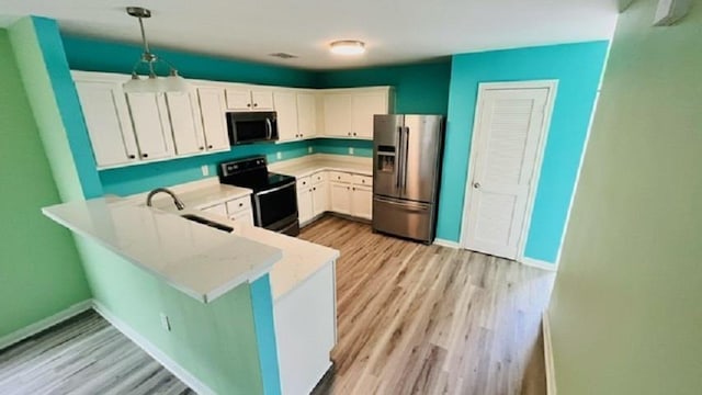 kitchen featuring white cabinetry, black electric range, stainless steel fridge, kitchen peninsula, and pendant lighting