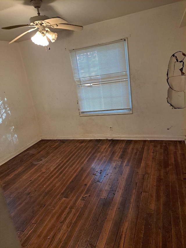 empty room with ceiling fan and dark wood-type flooring