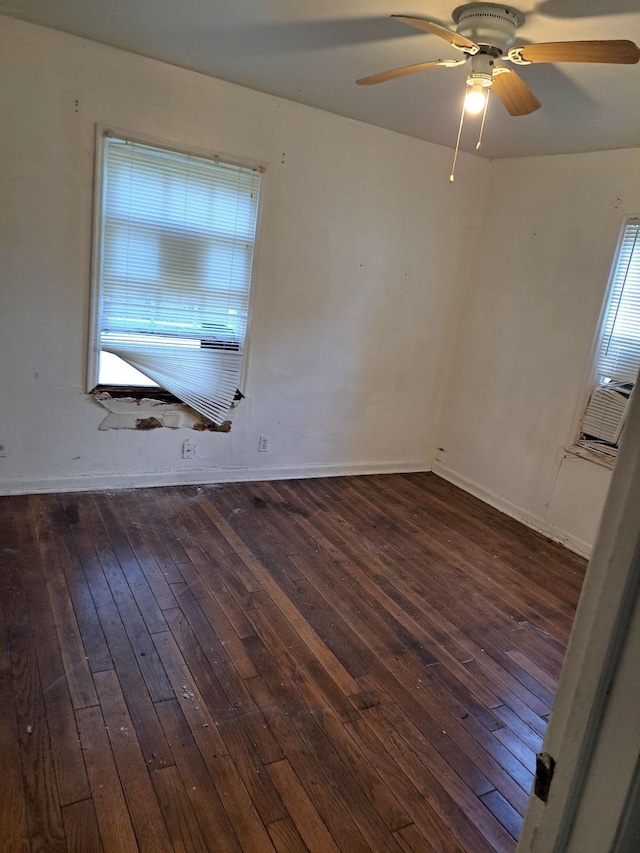 empty room with ceiling fan and dark wood-type flooring