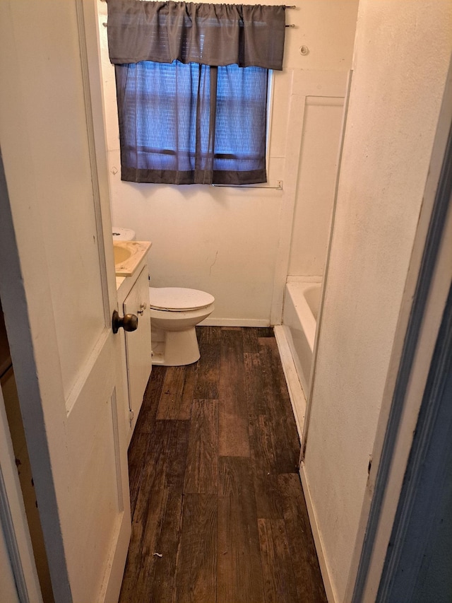 bathroom featuring vanity, hardwood / wood-style flooring, and toilet