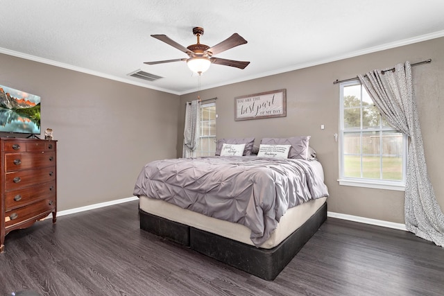 bedroom with ceiling fan, dark hardwood / wood-style floors, ornamental molding, and a textured ceiling