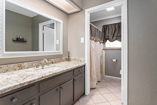 bathroom with tile patterned floors, vanity, and toilet