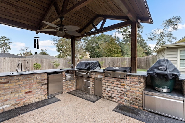 view of patio / terrace featuring a grill, ceiling fan, sink, and an outdoor kitchen