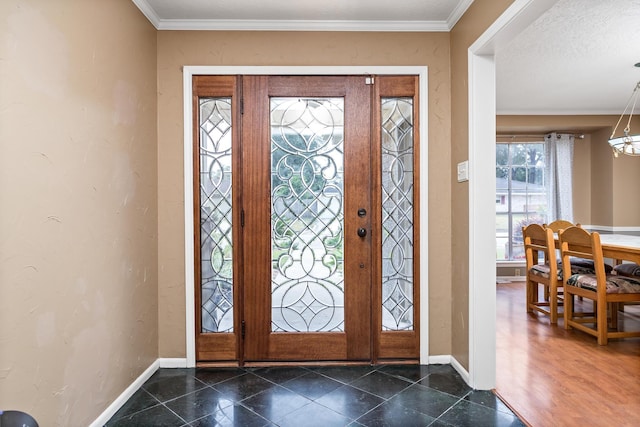 foyer entrance with a textured ceiling and ornamental molding