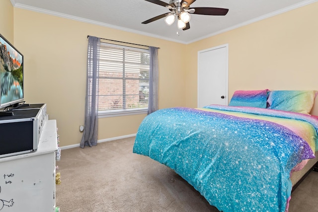 carpeted bedroom with ceiling fan and crown molding