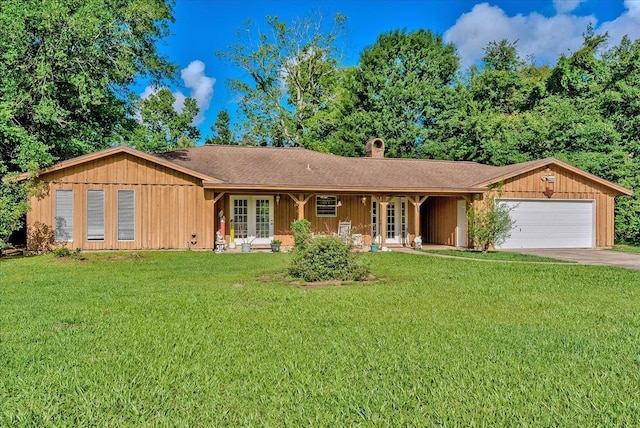 2322 Courtland St, West Orange, TX 77630 - ranch-style home featuring an attached garage, a front lawn, and french doors