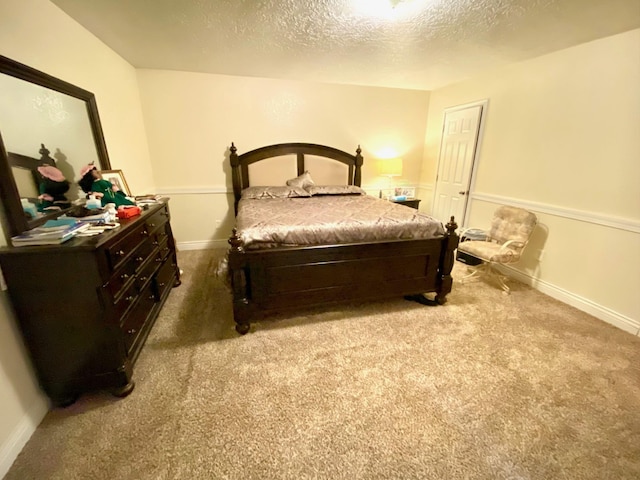 carpeted bedroom featuring a textured ceiling