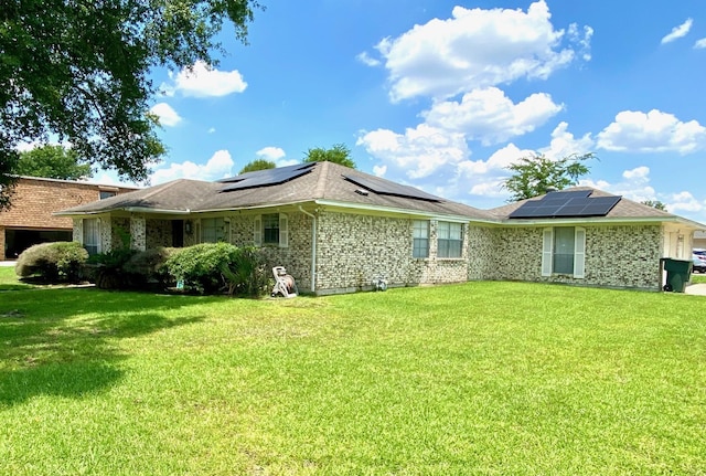 view of property exterior with a yard and solar panels