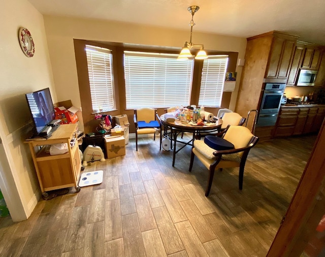 dining area with light hardwood / wood-style floors and a chandelier