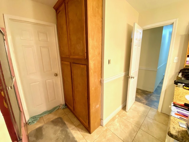 corridor featuring light tile patterned floors