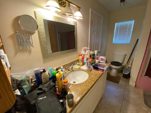 bathroom with tile patterned flooring, vanity, and toilet