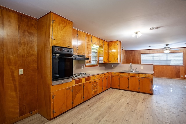 4612 Redbird St, Port Arthur, TX 77642 - kitchen featuring brown cabinetry, stainless steel gas stovetop, oven, and a sink