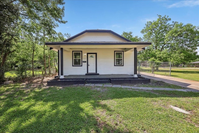 bungalow-style home with a porch and a front yard
