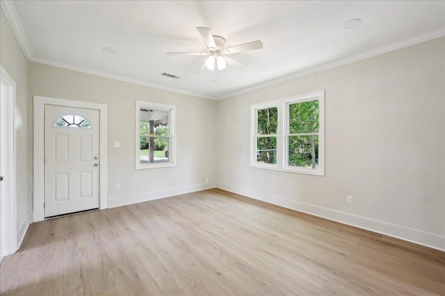 entrance foyer with crown molding, a ceiling fan, visible vents, light wood-style flooring, and baseboards