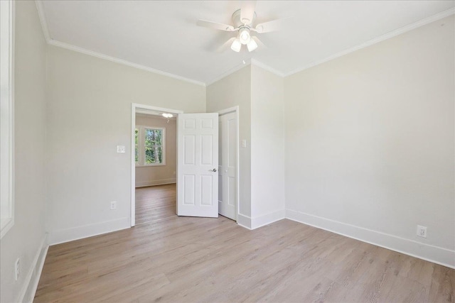 empty room featuring baseboards, a ceiling fan, and light wood-style flooring
