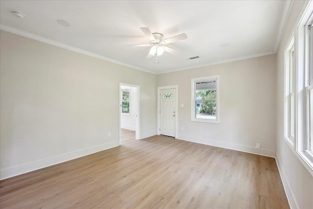 unfurnished room with light wood finished floors, visible vents, ceiling fan, and plenty of natural light